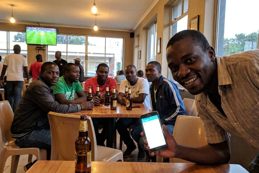 Football fans watching a match in a Harare sports bar